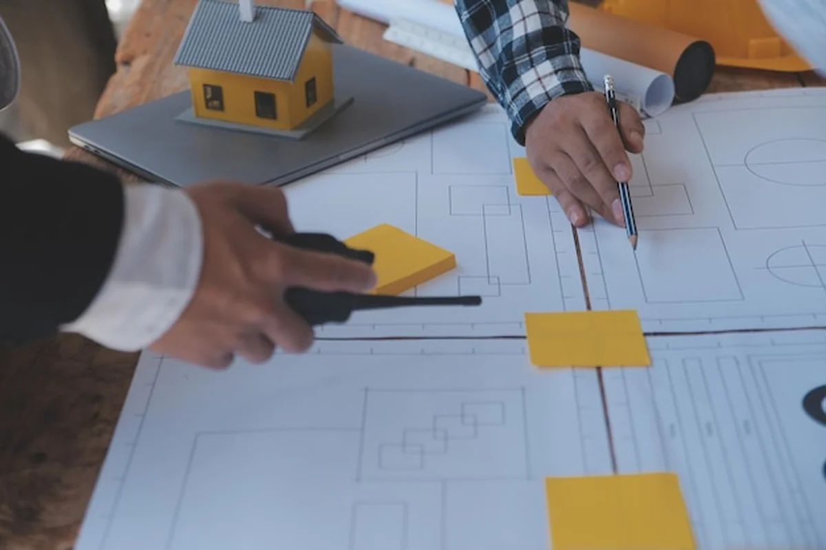 Inżynierowie pracujący nad projektem budowlanym w biurze nad rysunkiem i narzędziami inżynieryjnymi